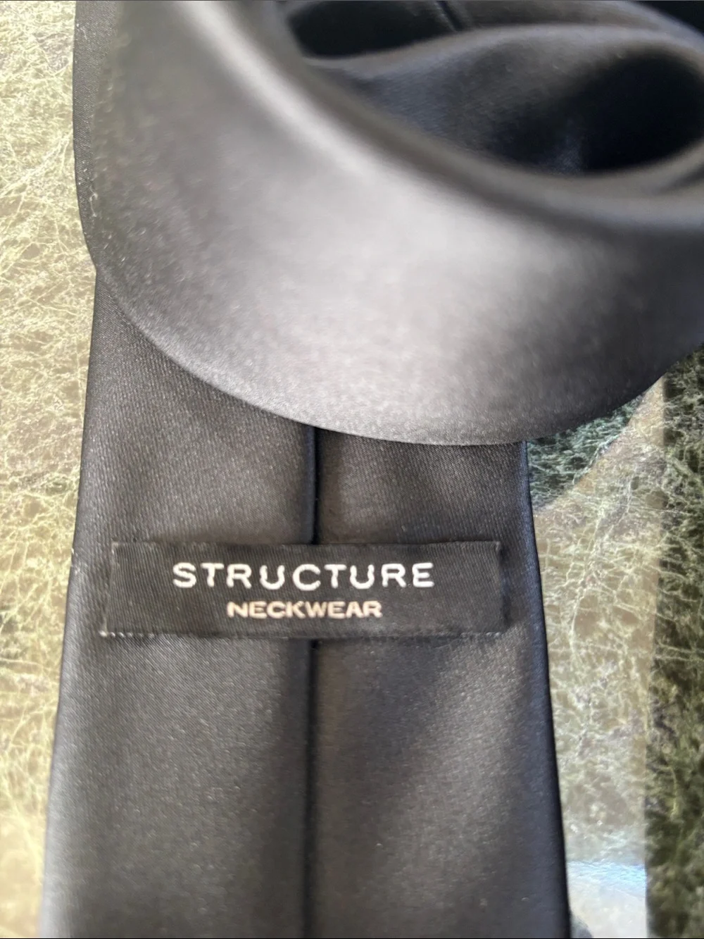 Structure Neckwear solid black tie features a classic, smooth satin finish.